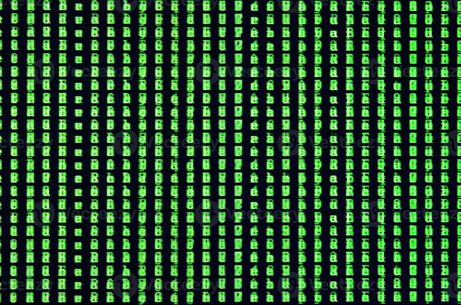 Macro shot of a glitch on the monitor of an office computer. The concept of introducing a virus into a personal data keeper. Stream of random green symbols on a black background photo