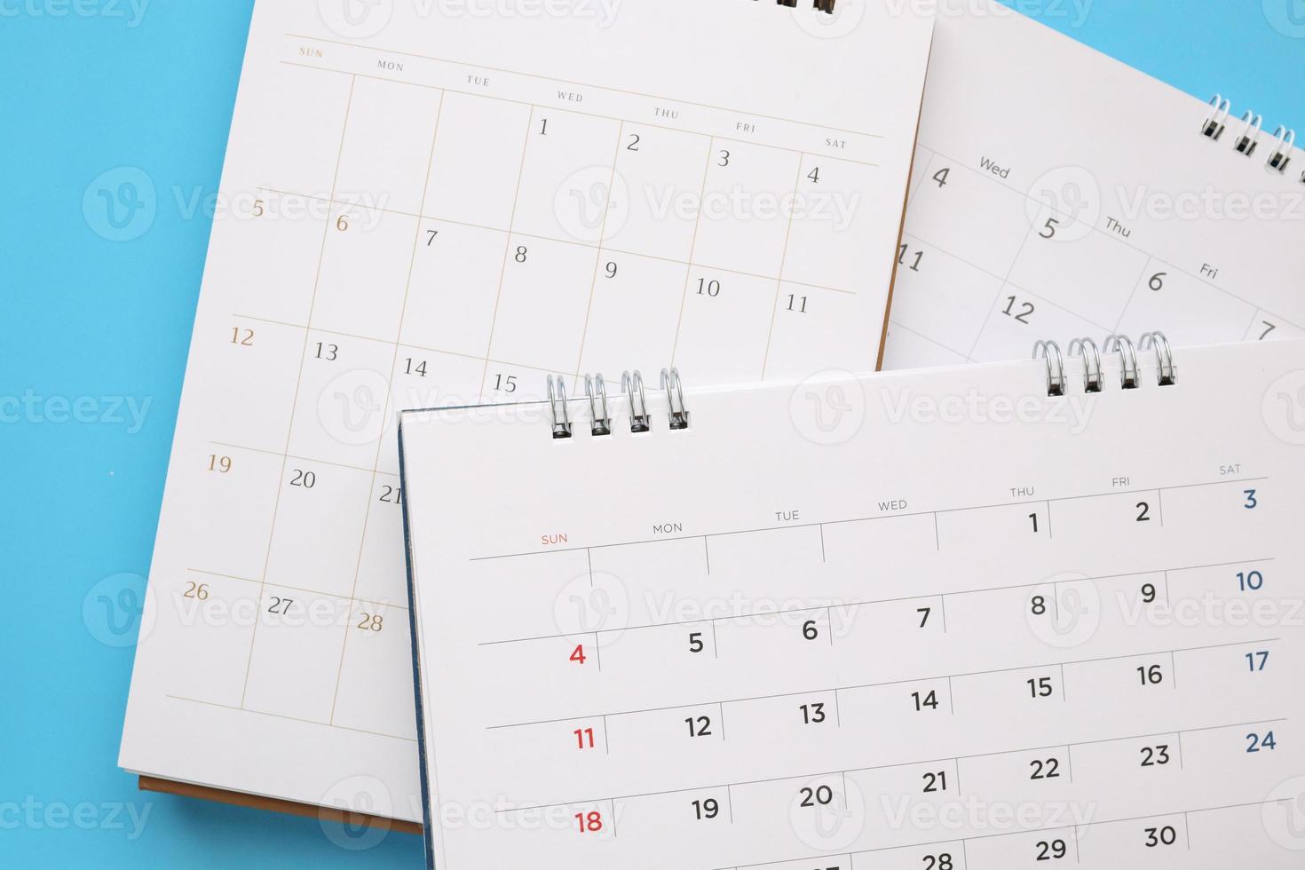 calendar page close up on blue background business planning appointment meeting concept photo