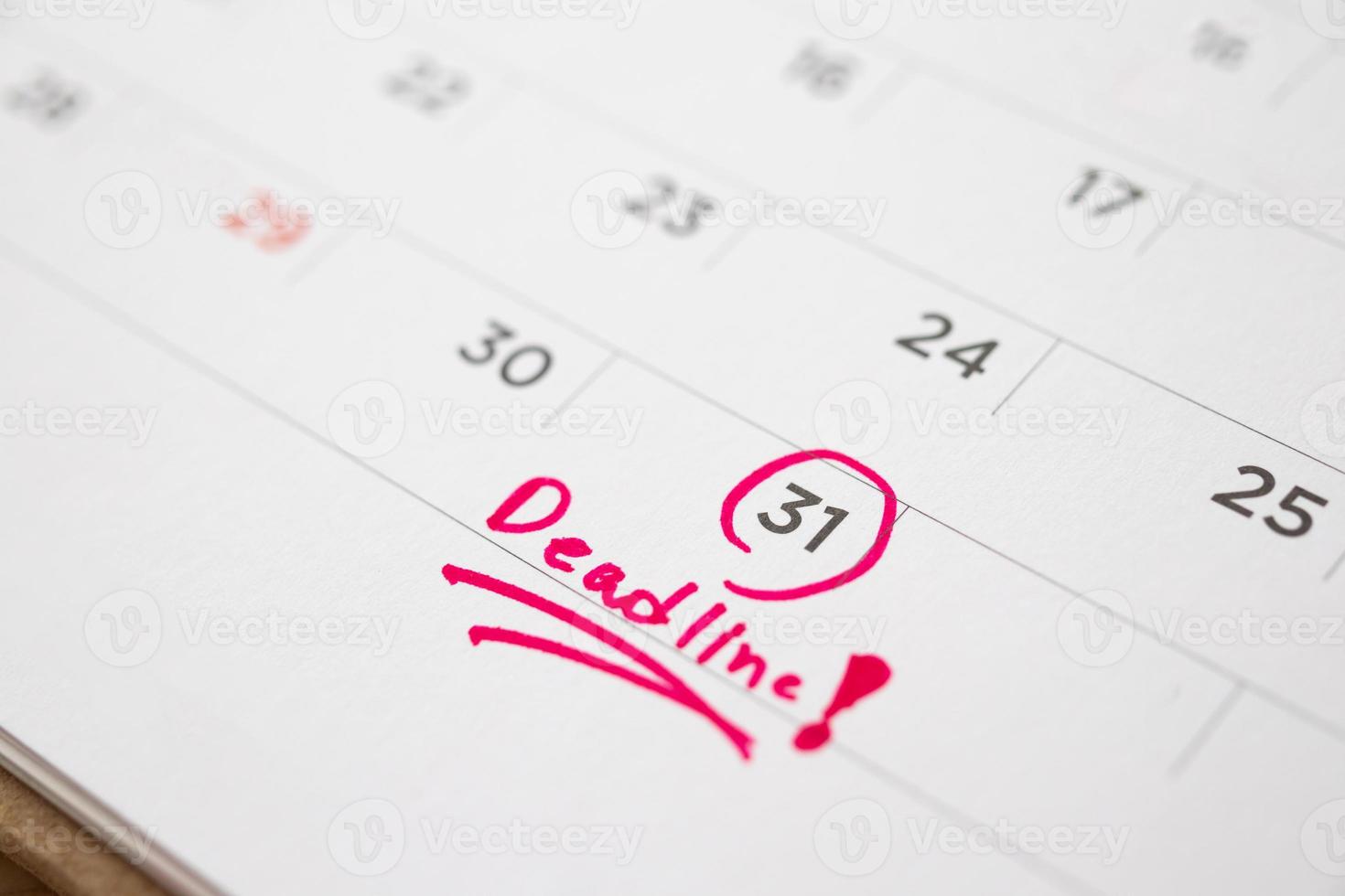 Deadline write on white calendar page date close up photo