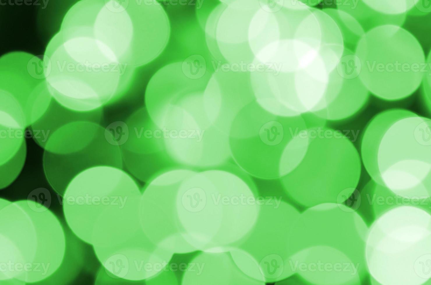 Green abstract Christmas blurred luminous background. Defocused artistic bokeh lights image photo