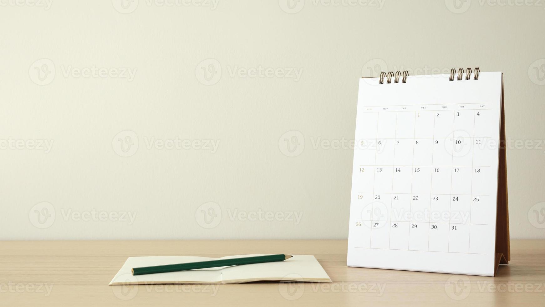 calendar page close up on wood table background with pencil and notebook business planning appointment meeting concept photo