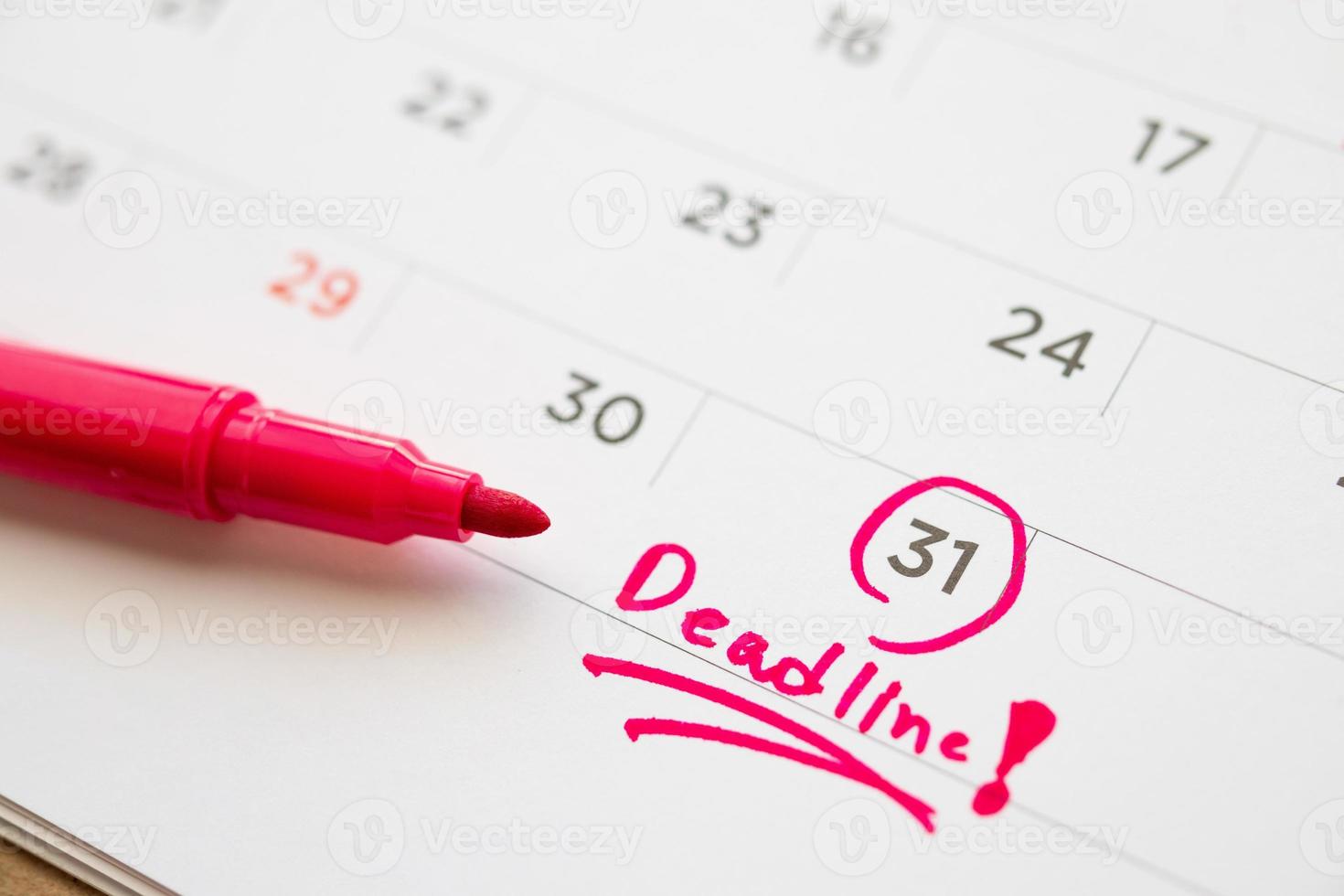 Deadline write on white calendar page date close up photo