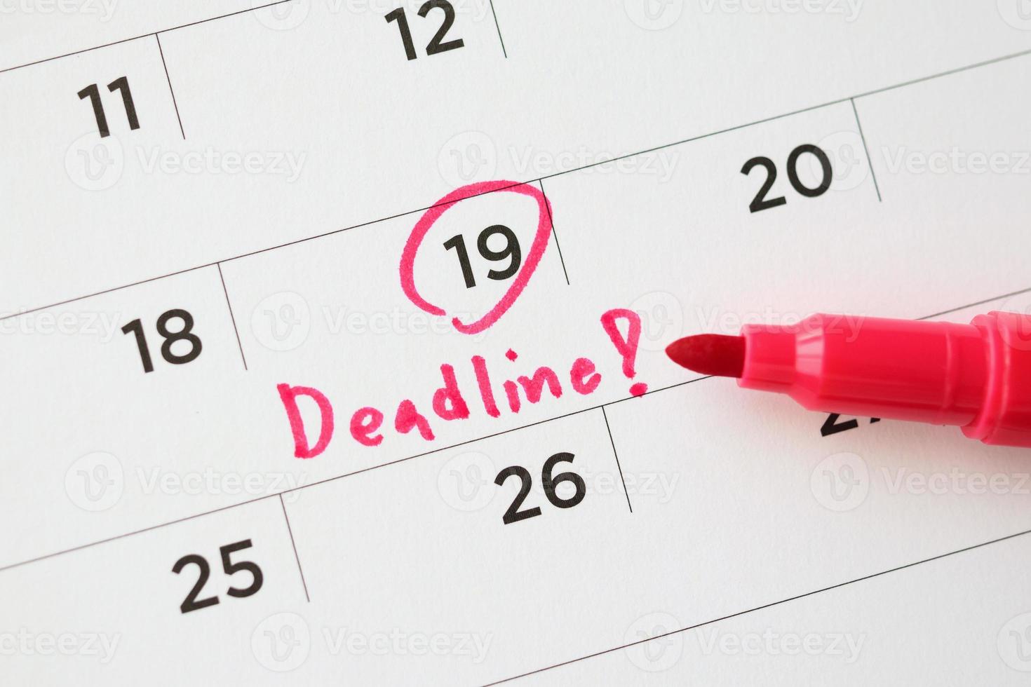 Deadline write on white calendar page date close up photo