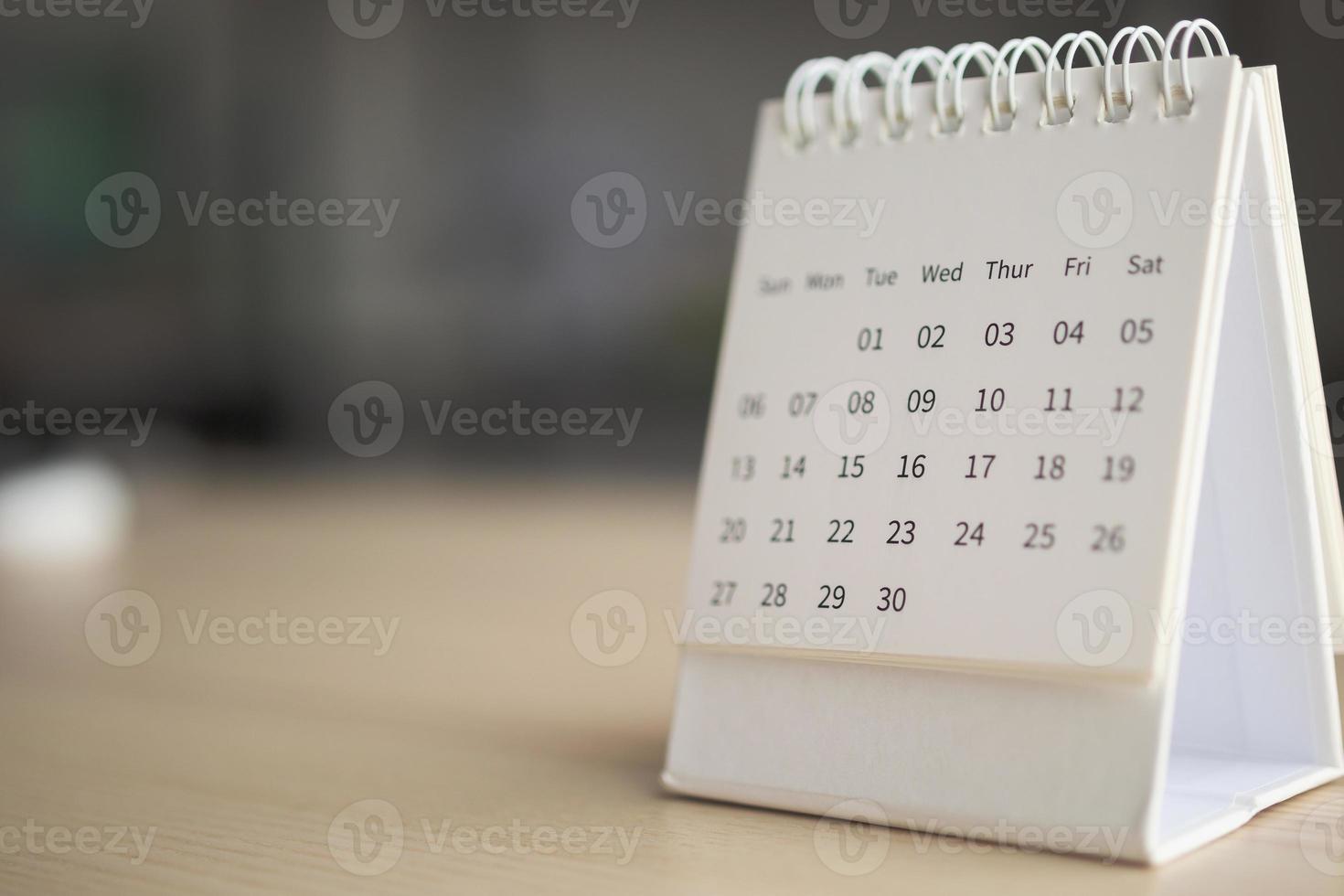 Calendar page close up on wood table background business planning appointment meeting concept photo