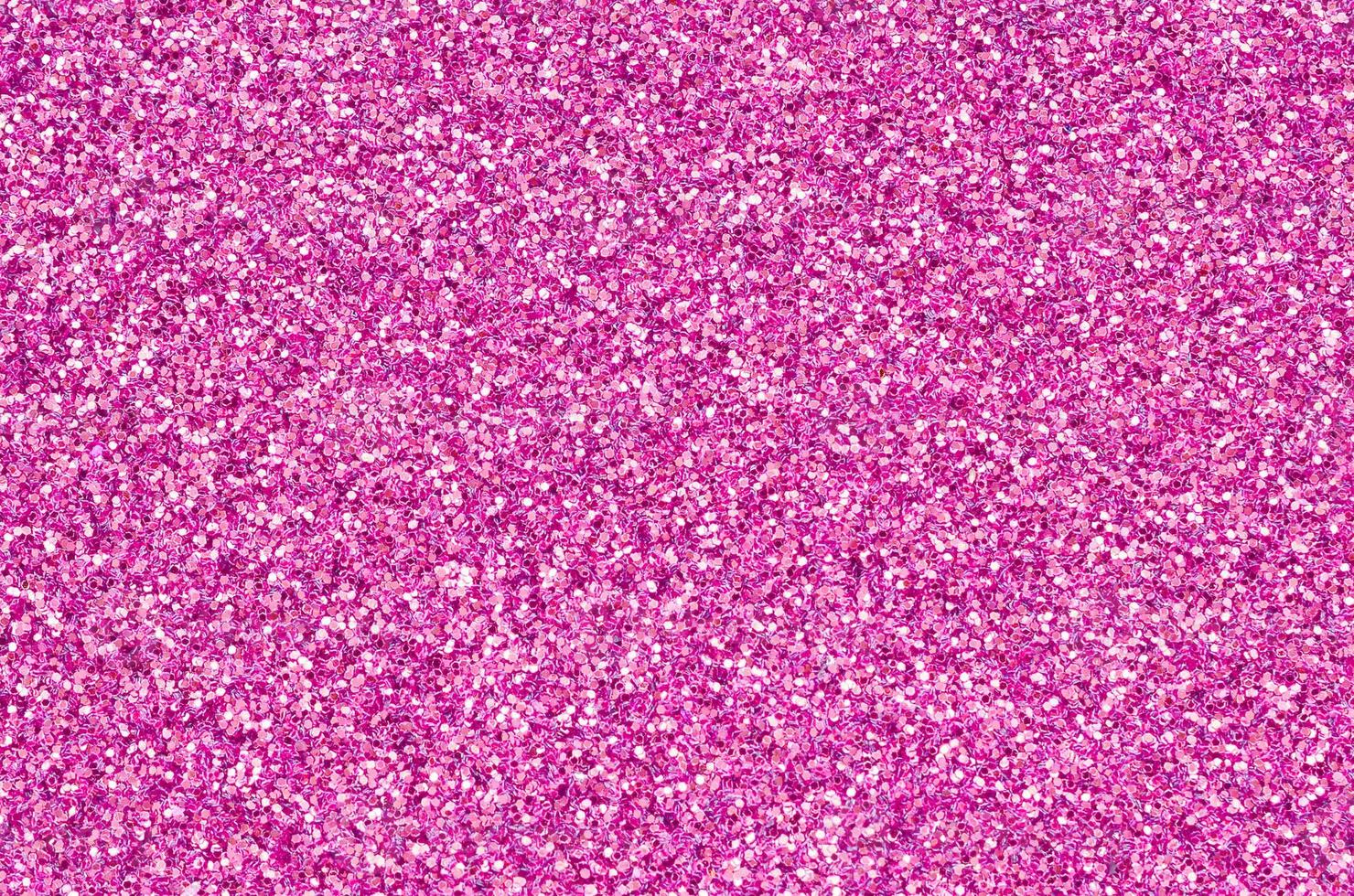 Pink decorative sequins. Background image with shiny bokeh lights from small elements photo