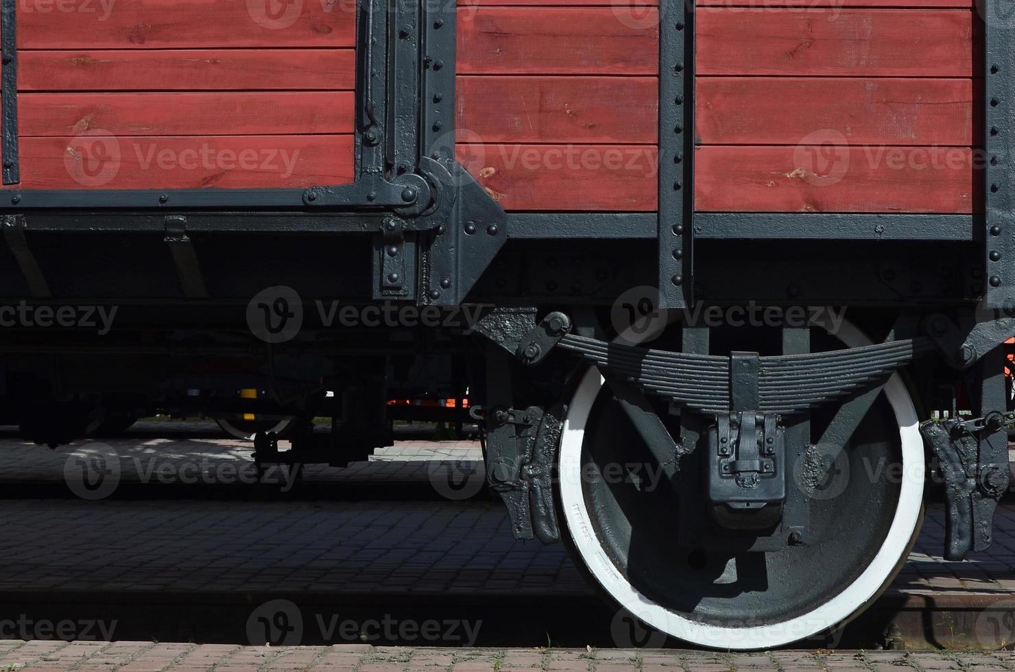 The side of the old brown wooden freight car with the wheel of the times of the Soviet Union photo