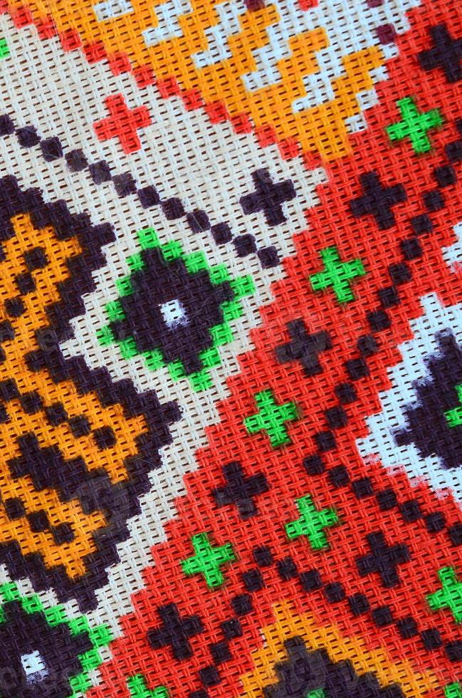 Traditional Ukrainian folk art knitted embroidery pattern on textile fabric photo