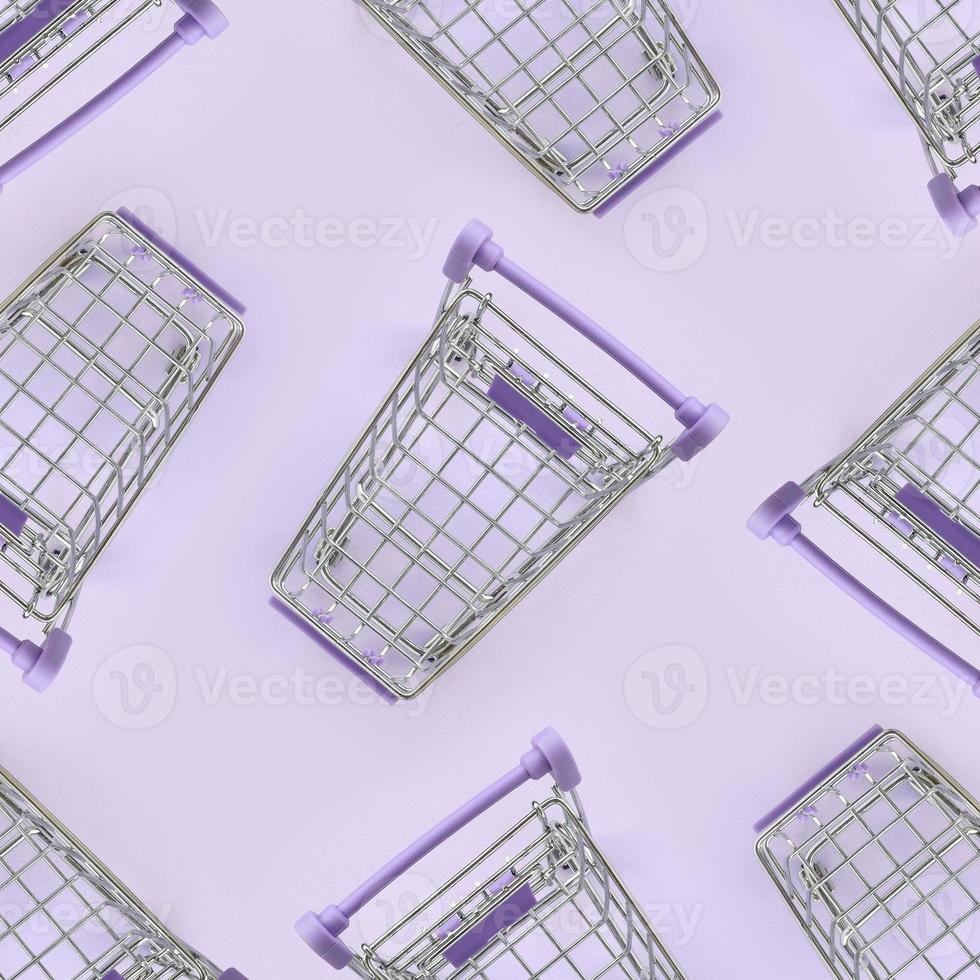 Pattern of many small shopping carts on a violet background. Minimalism flat lay top view photo