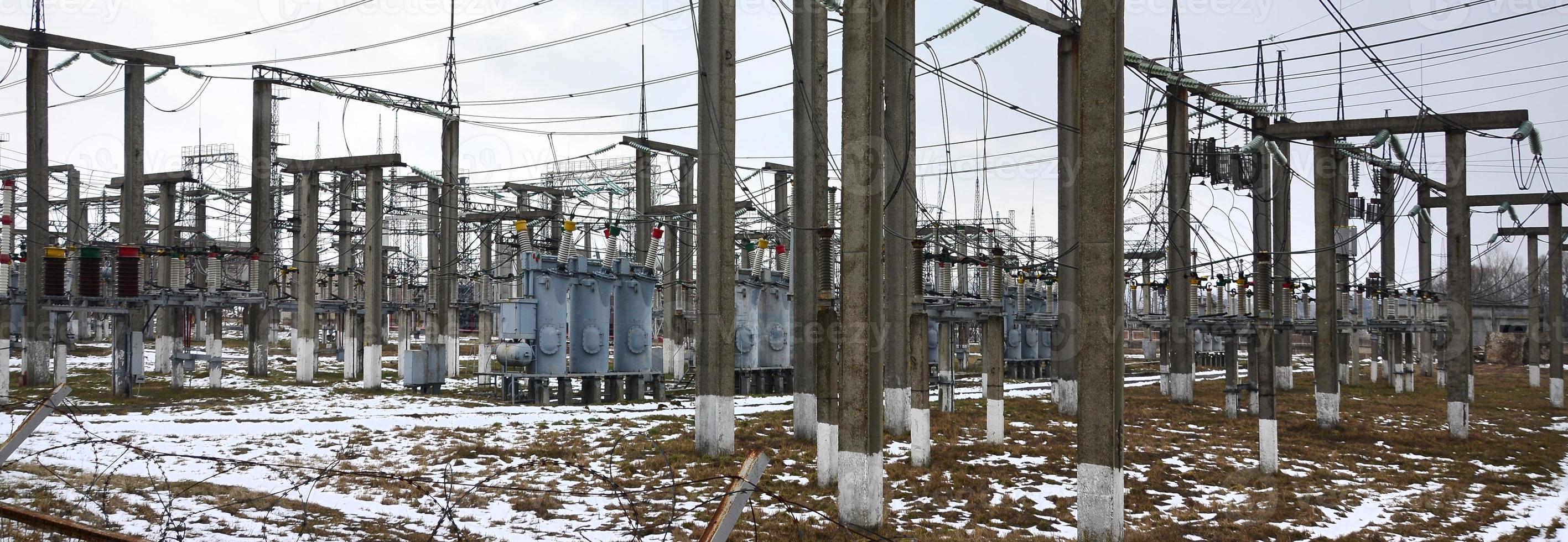 Power plant is a station of transformation. A lot of cables, poles and wires, transformers. Electro-energy. photo