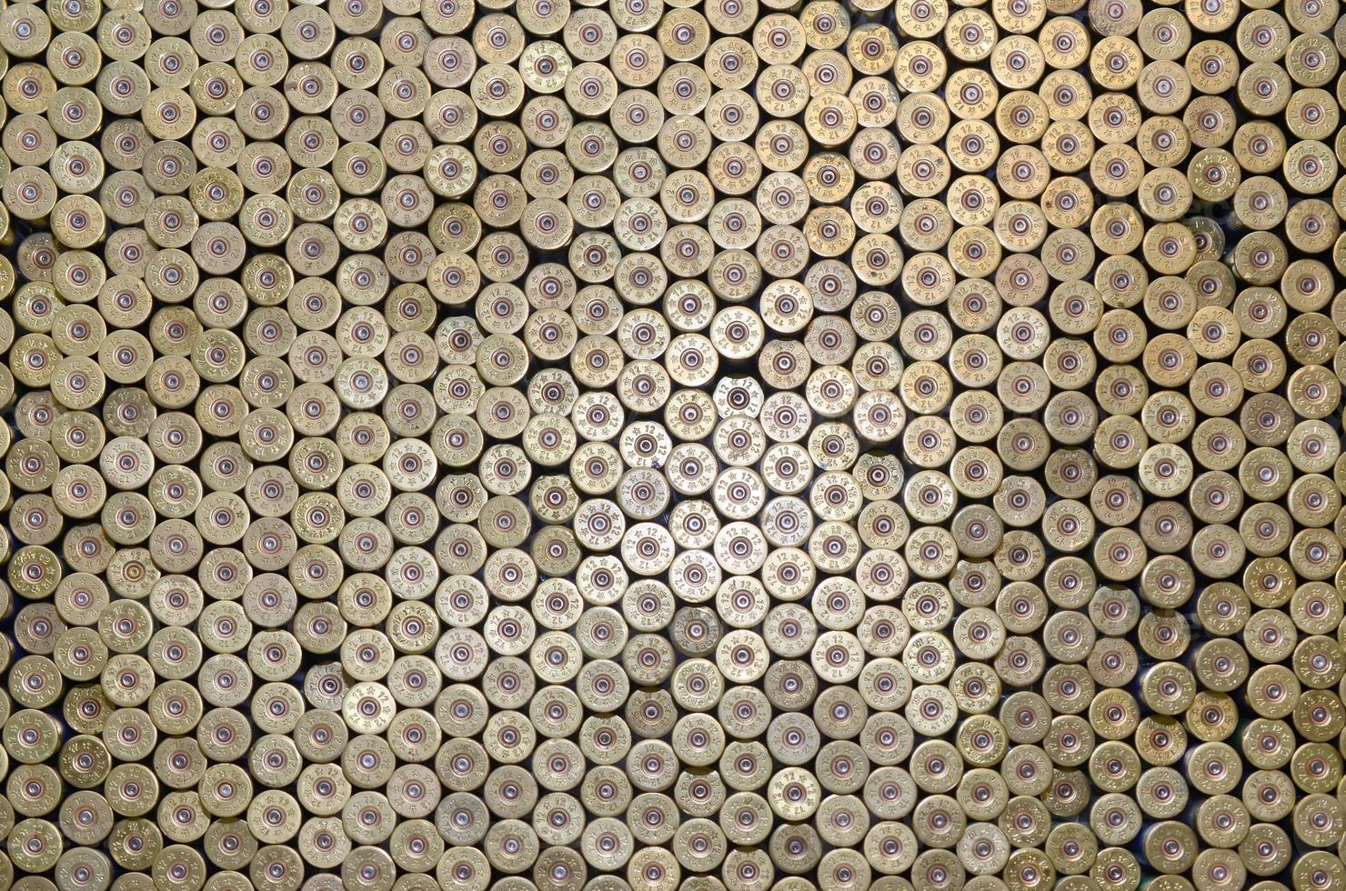 Pattern of 12 gauge cartridges for shotgun bullets. Shells for hunting rifle close up. Backdrop for shooting range or ammunition trade concepts photo