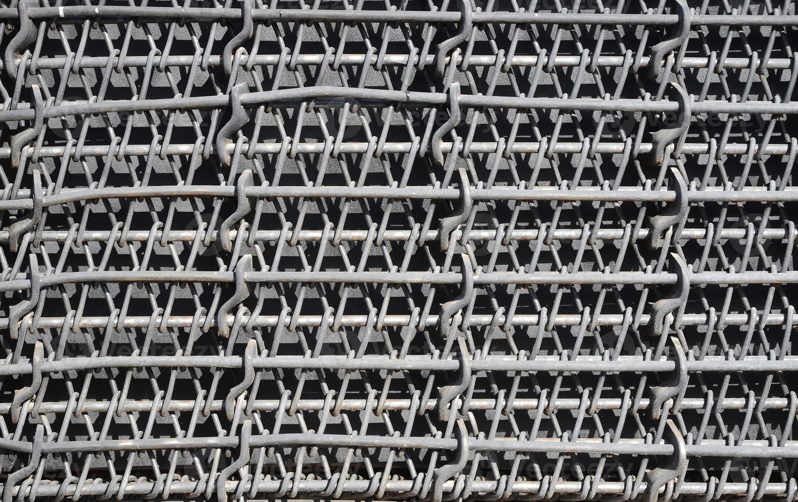 Metal multilayered thick grid of black color. Composite texture photo