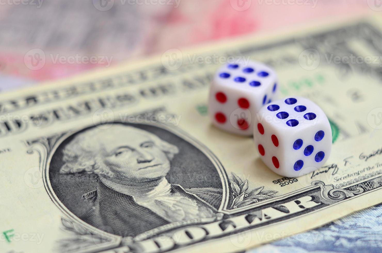 White dice are on a dollar bill of US dollars. The concept of gambling with rates in monetary units photo