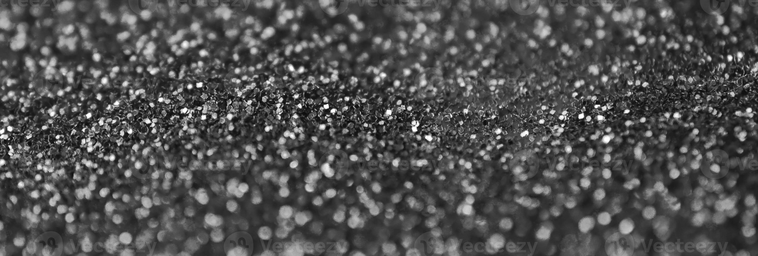 Silver decorative sequins. Background image with shiny bokeh lights from small elements photo