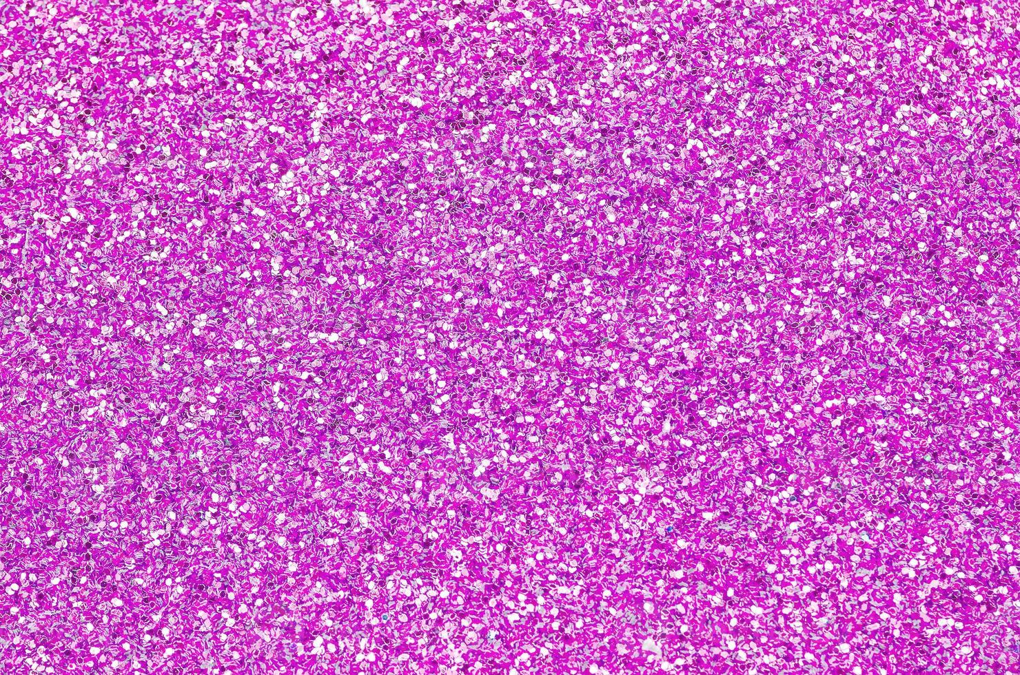 Pink decorative sequins. Background image with shiny bokeh lights from small elements photo