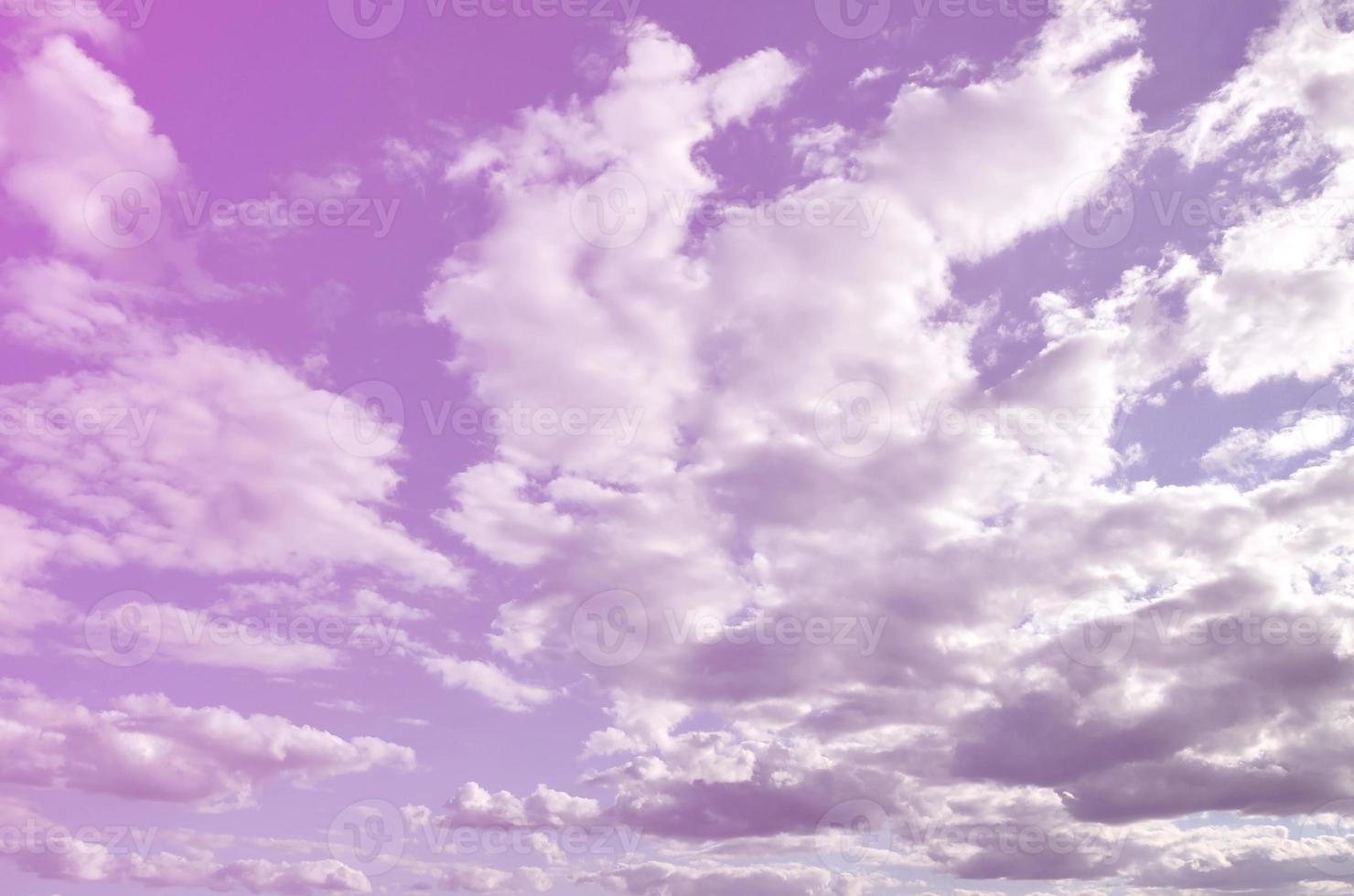 A blue cloudy sky with many small clouds blocking the sun photo