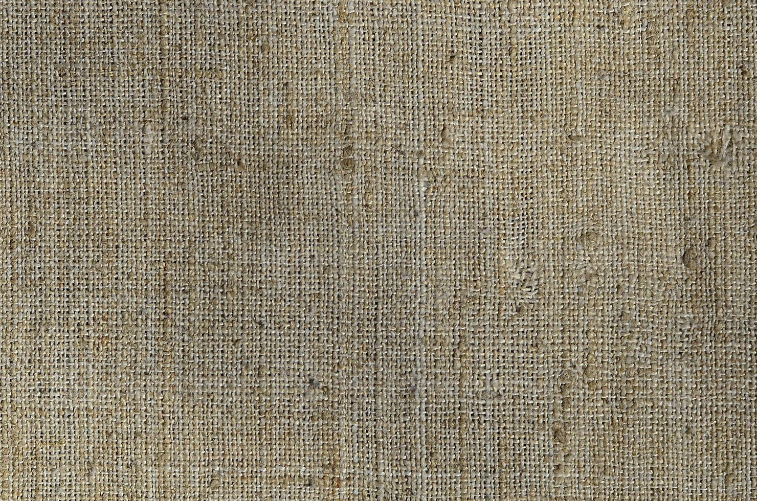 Texture of a gray canvas made of old and coarse burlap. Top view photo
