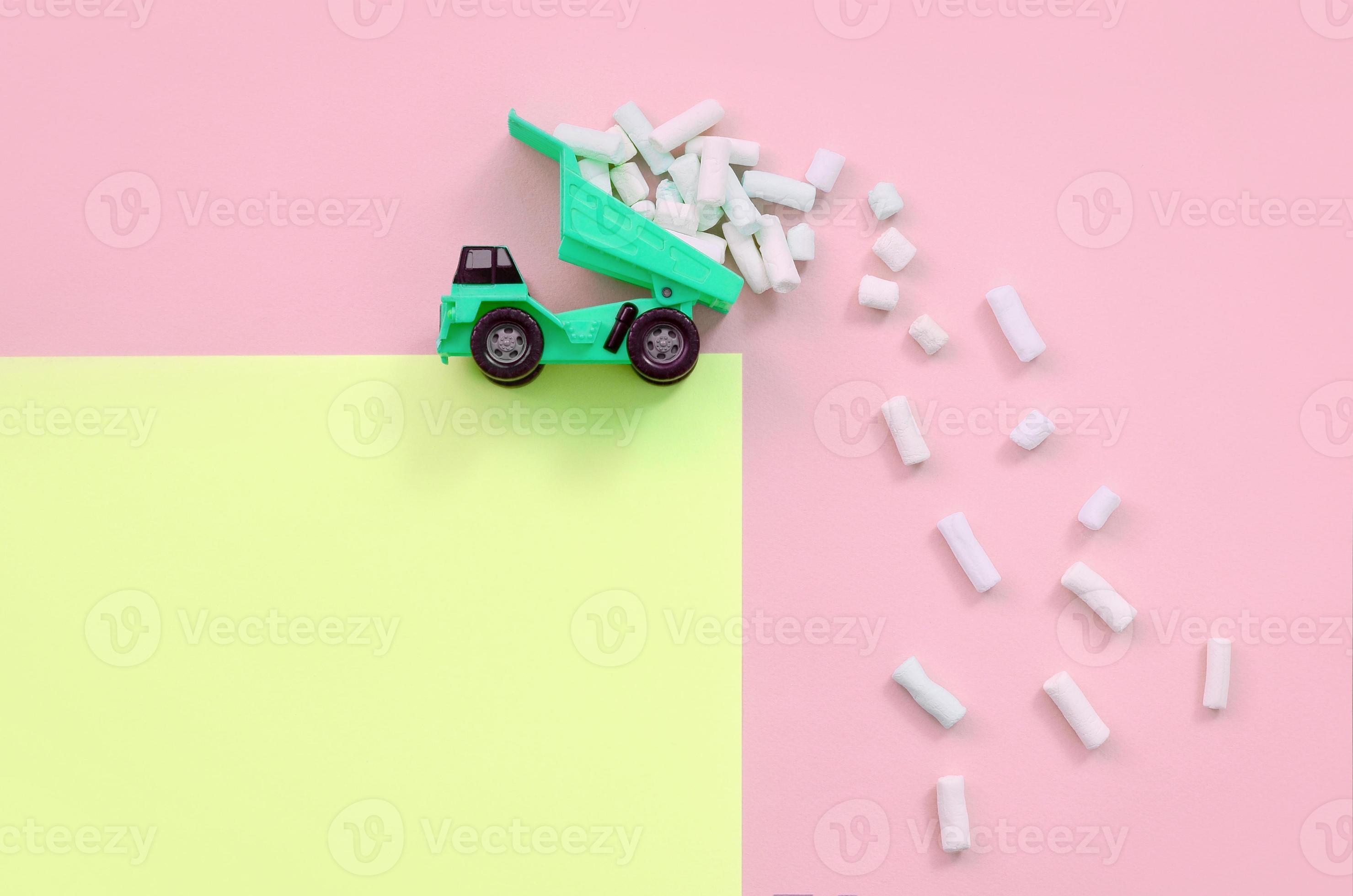 Dump truck throws marshmallow pieces from its raised back 12914080
