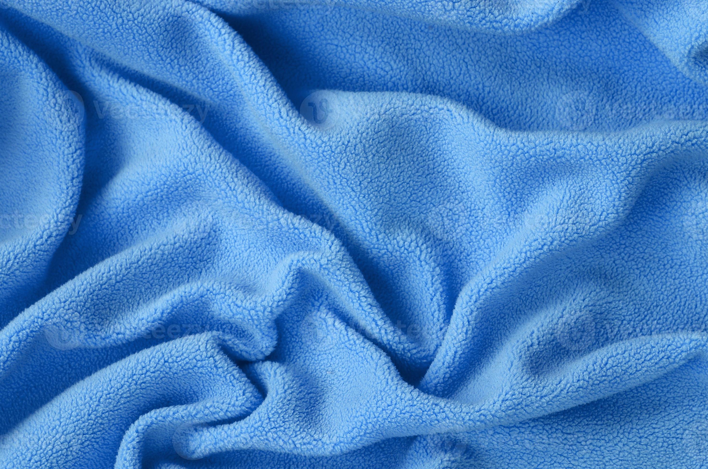 The blanket of furry blue fleece fabric. A background of light