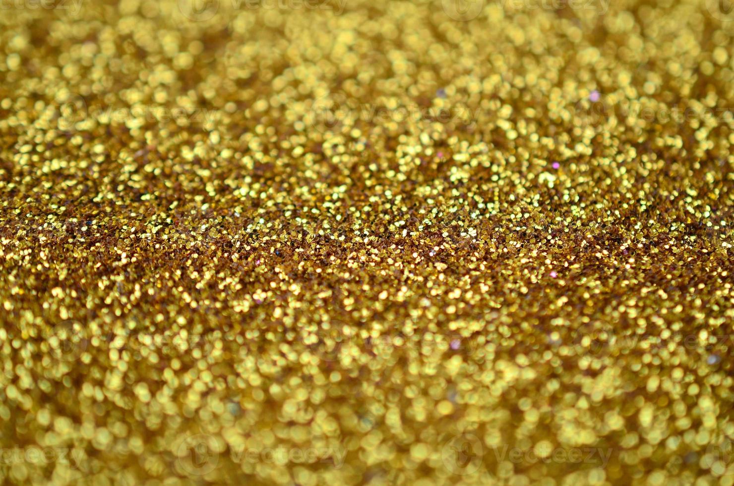 A huge amount of yellow decorative sequins. Background texture with shiny, small elements that reflect light in a random order. Glitter texture photo