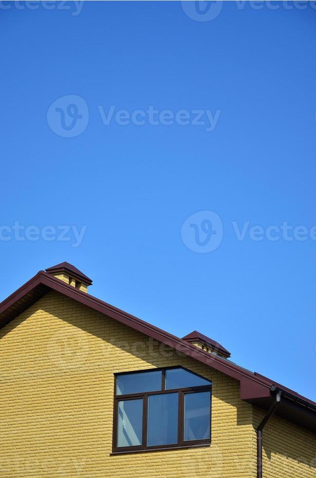 The top of a residential building of yellow brick photo