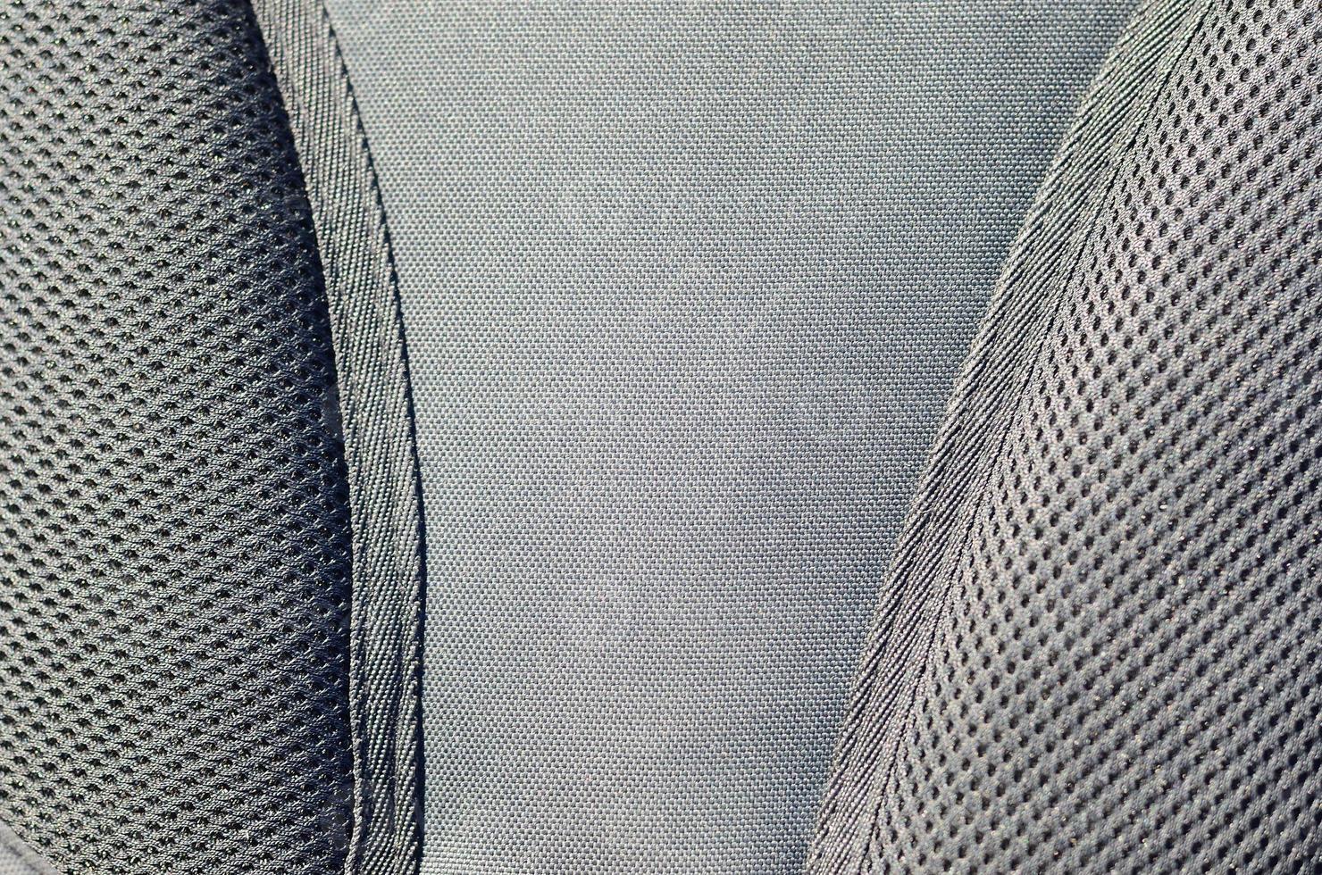 closeup of texture breathable mesh fabric in the black photo backpack. Texture of Black Plastic Weave Bag. Background image