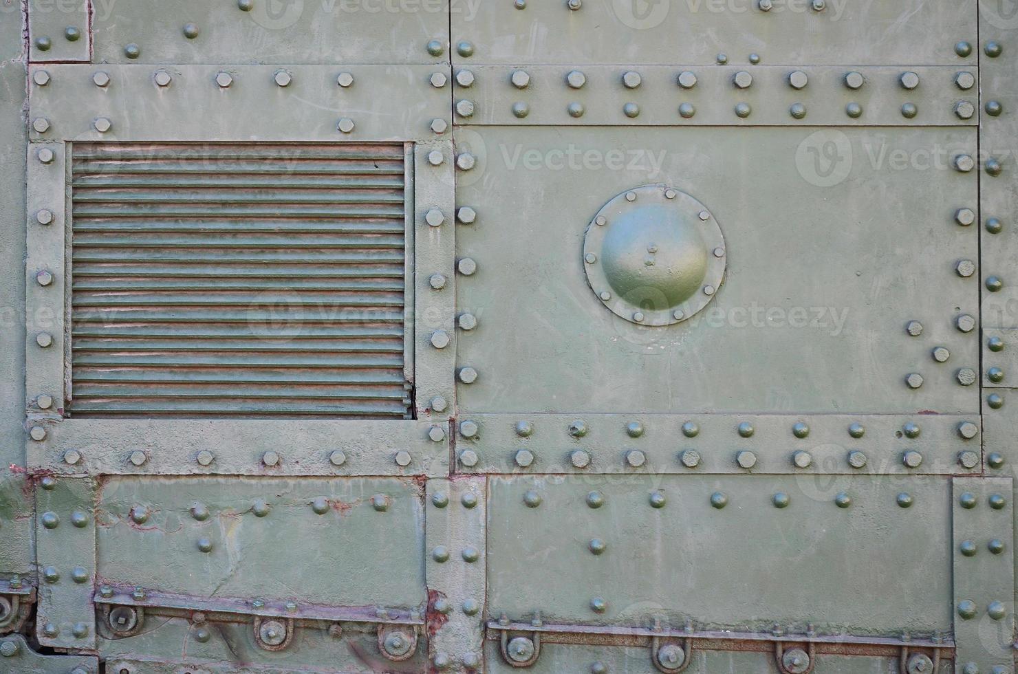 The texture of the wall of the tank, made of metal and reinforced with a multitude of bolts and rivets. Images of the covering of a combat vehicle from the Second World War photo