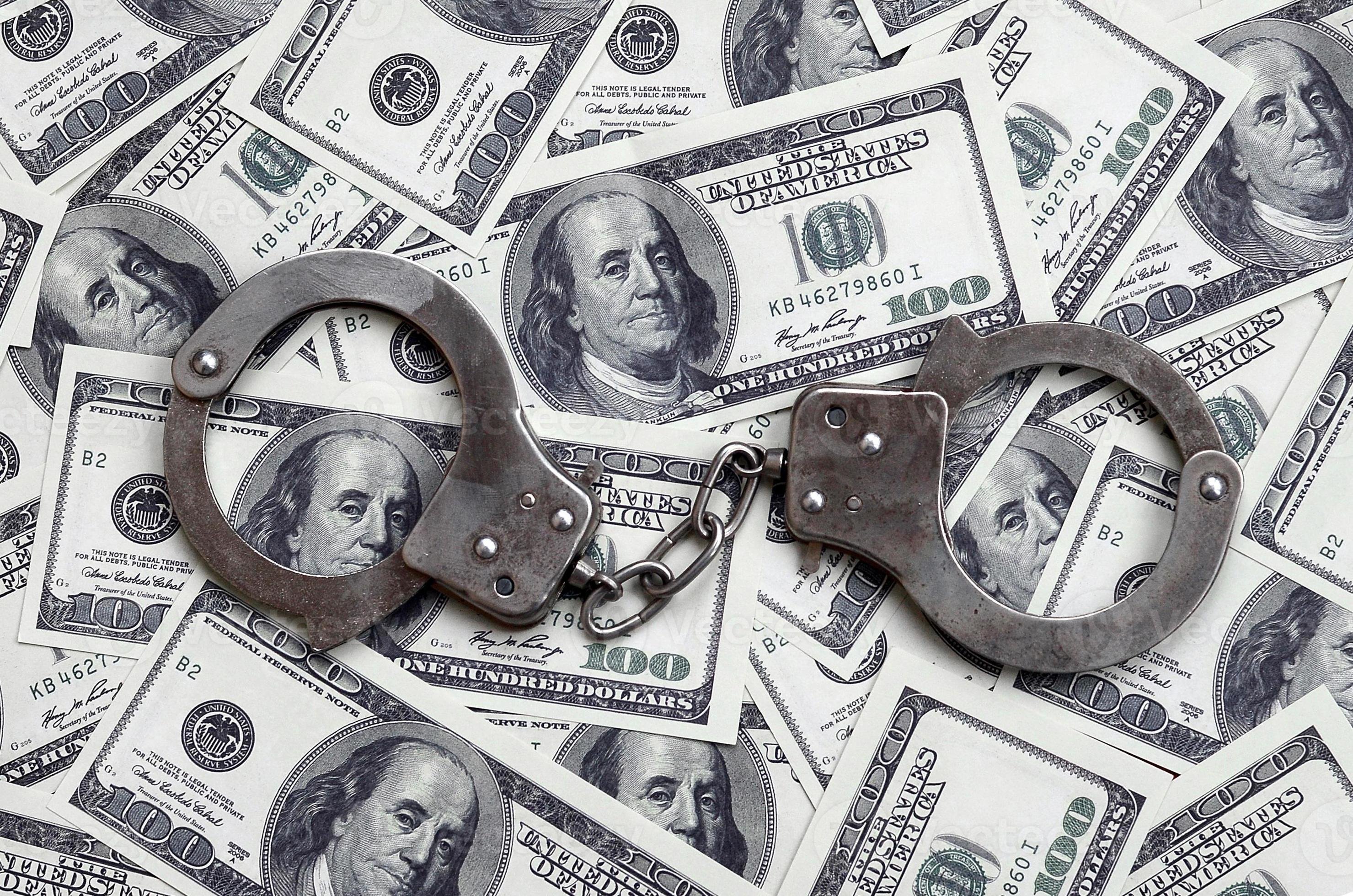 What Is Unlawful Transaction With A Minor Police handcuffs lie on a lot of dollar bills. The concept of illegal
