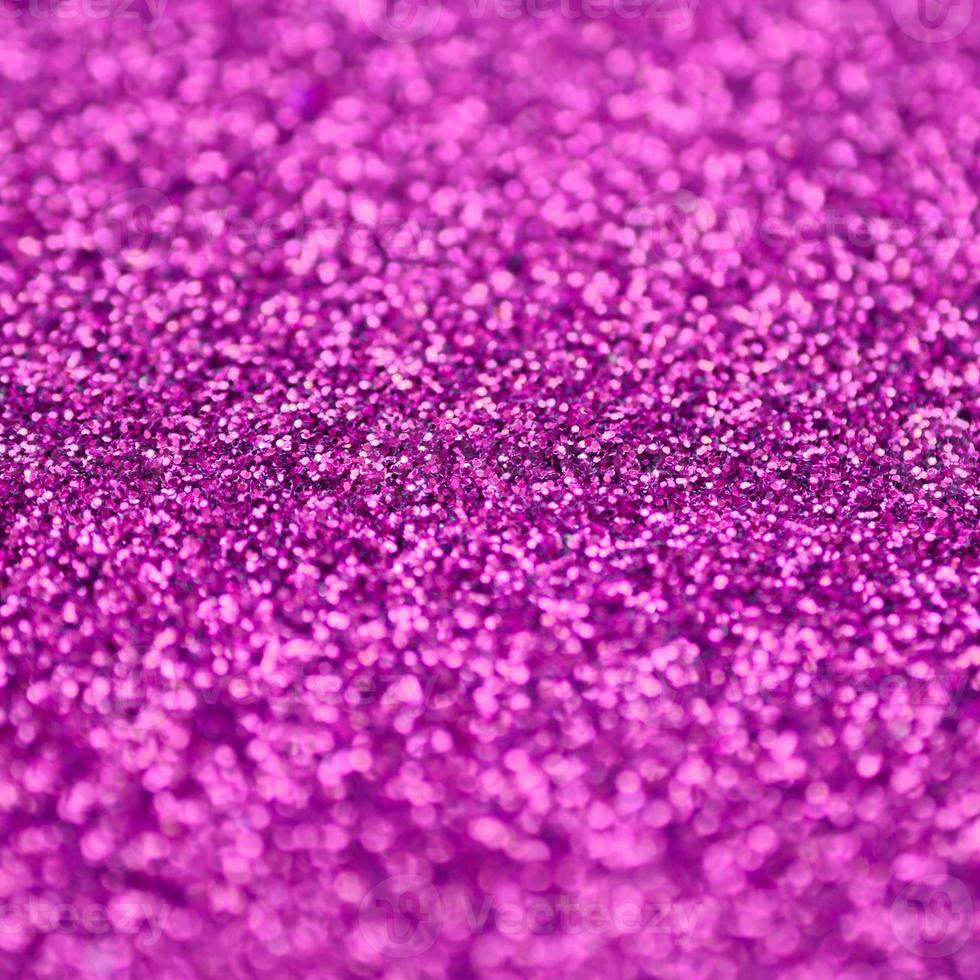 Pink decorative sequins. Background image with shiny bokeh lights from small elements photo