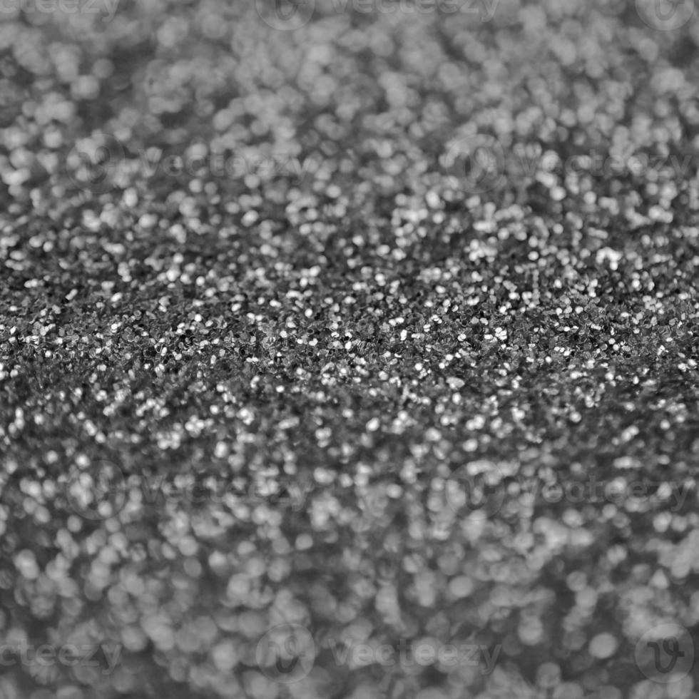 Silver decorative sequins. Background image with shiny bokeh lights from small elements photo