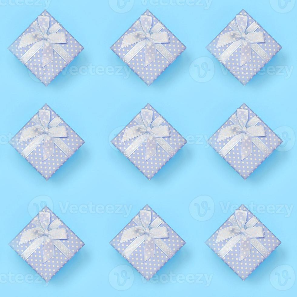 A lot of blue gift boxes lies on texture background of fashion pastel blue color paper in minimal concept photo