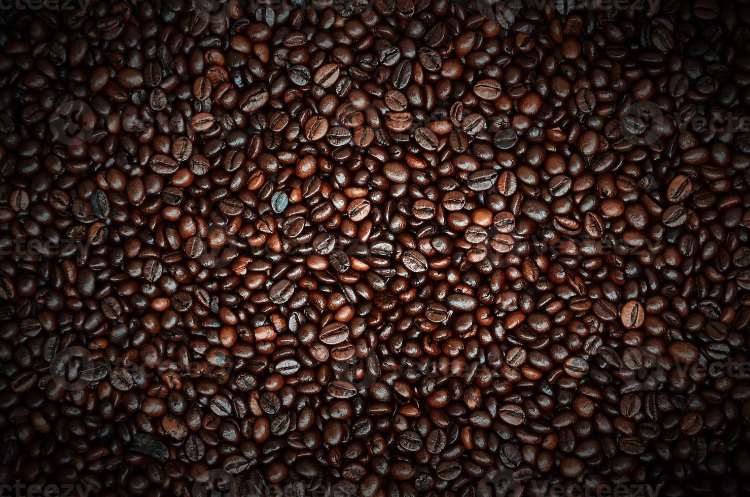 Background texture of a huge number of fragrant and fresh brown roasted coffee grains photo
