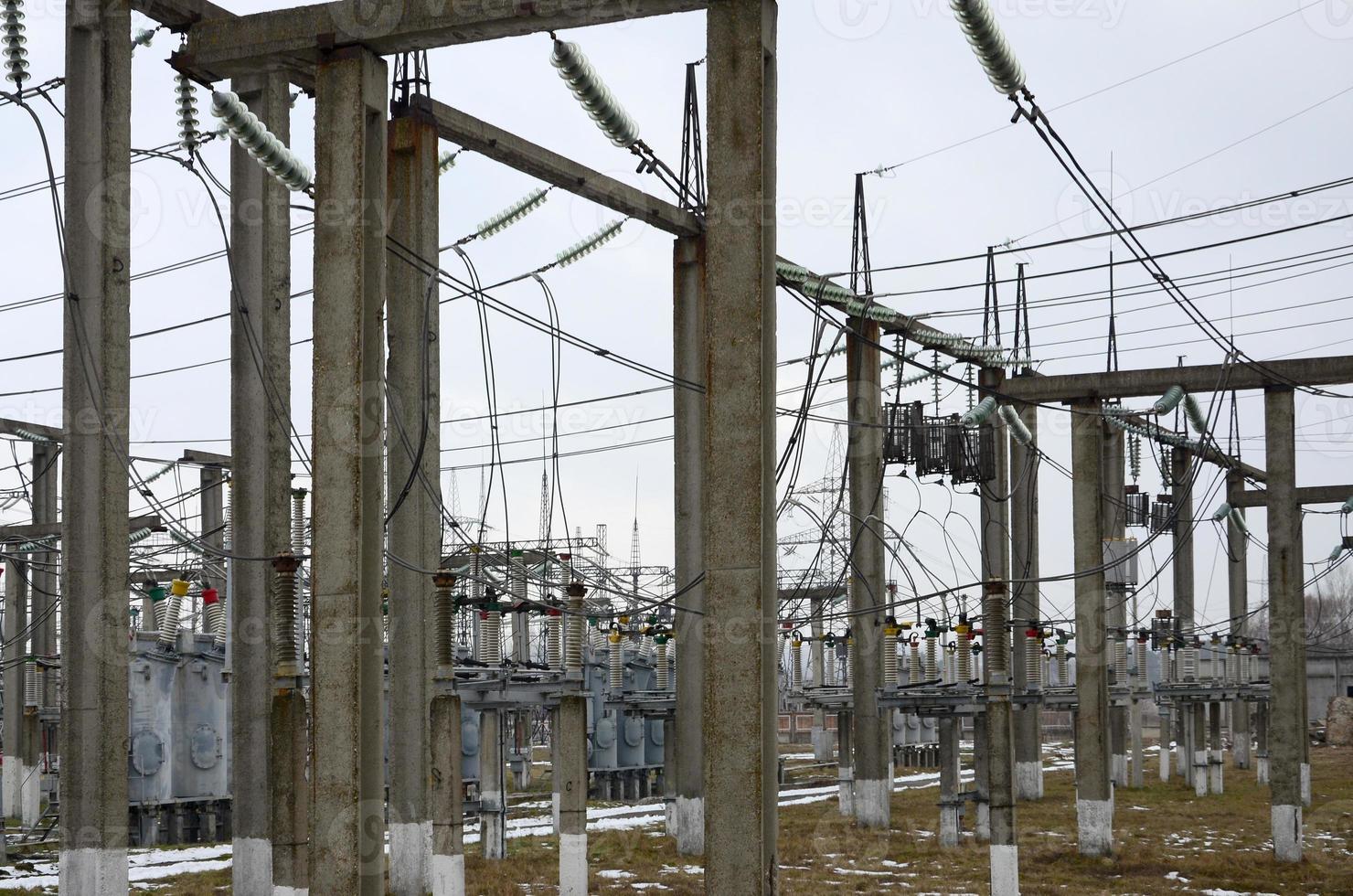 Power plant is a station of transformation. A lot of cables, poles and wires, transformers. Electro-energy. photo