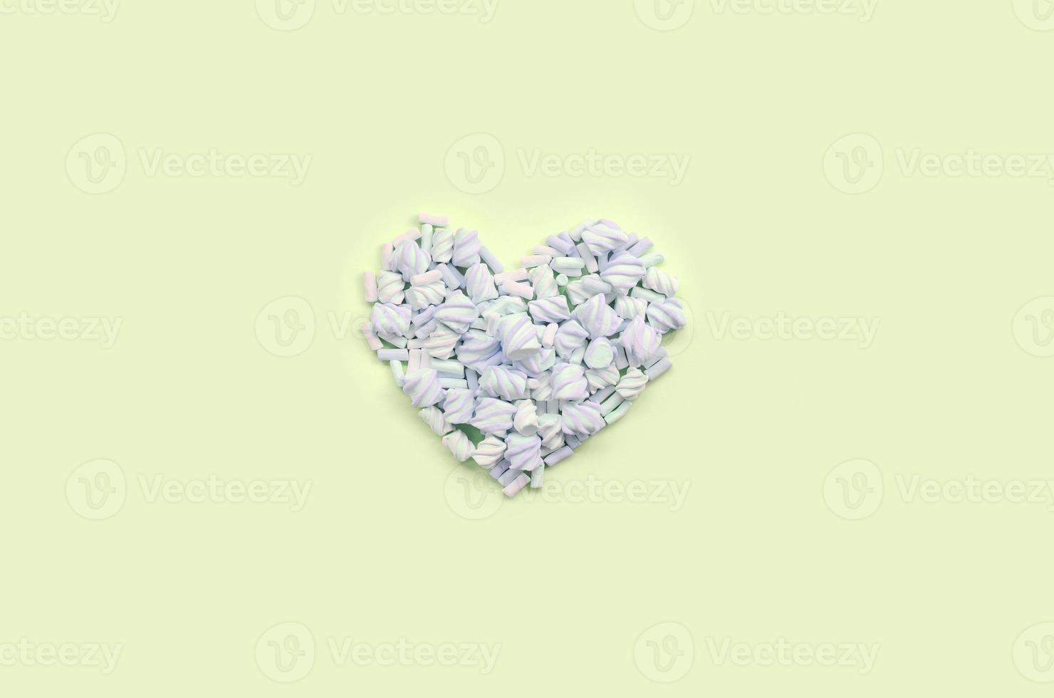 Colorful marshmallow laid out on lime and pink paper background. pastel creative textured heart photo