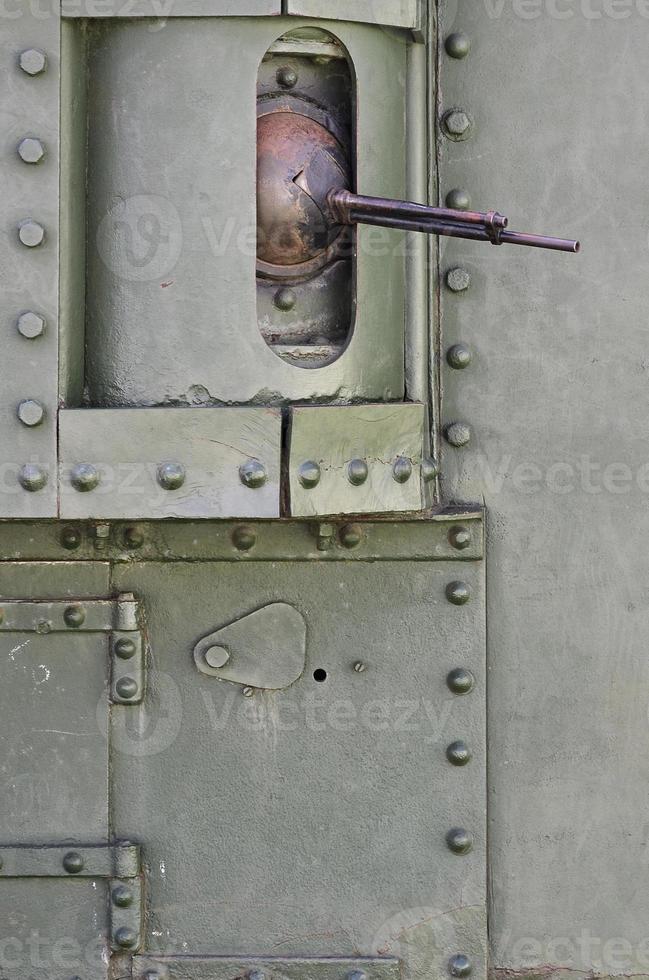 The texture of the wall of the tank, made of metal and reinforced with a multitude of bolts and rivets. Images of the covering of a combat vehicle from the Second World War with a guided machine gun photo