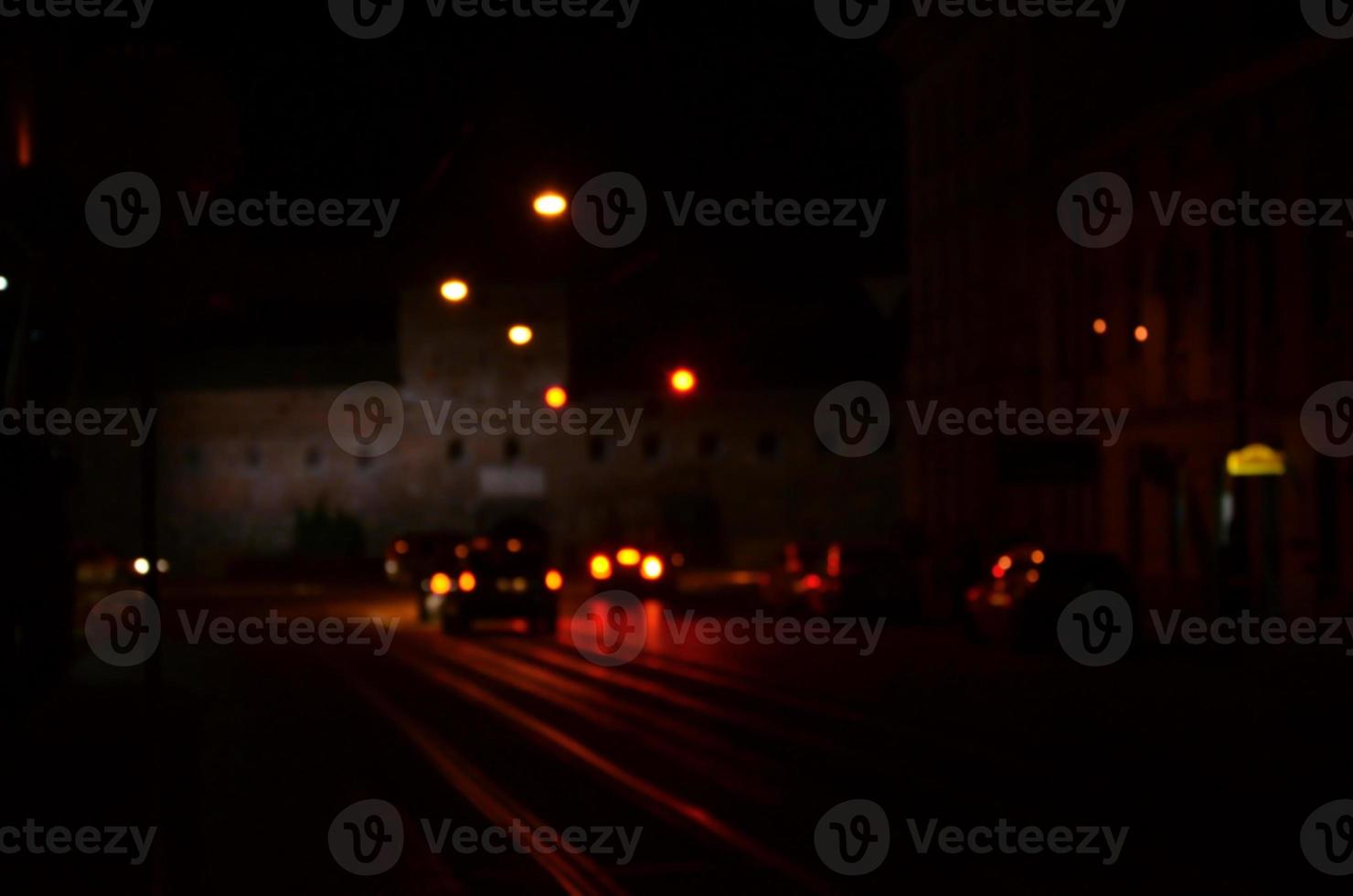 Blurred night scene of traffic on the roadway. Defocused image of cars traveling with luminous headlights. Bokeh Art photo