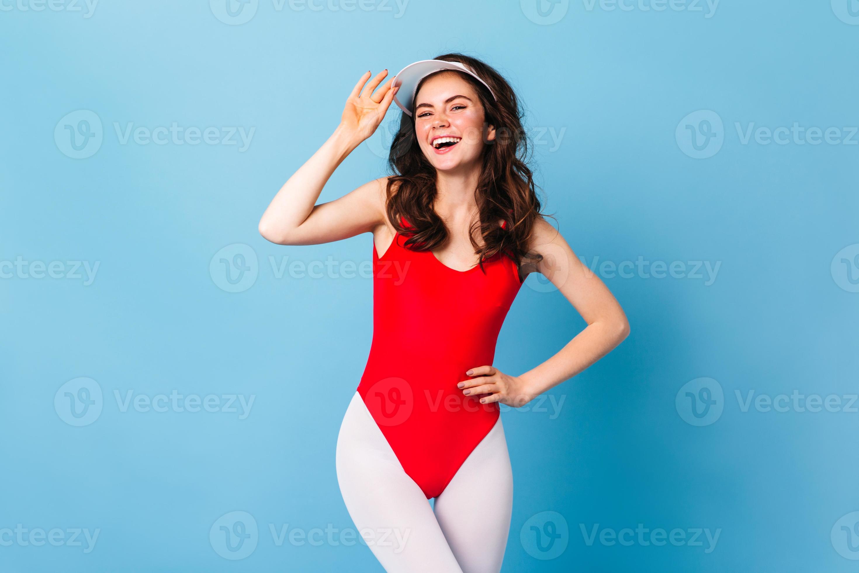 Charming athlete girl in bodysuit and white leggings in style of 80s laughs  on blue background 12923172 Stock Photo at Vecteezy