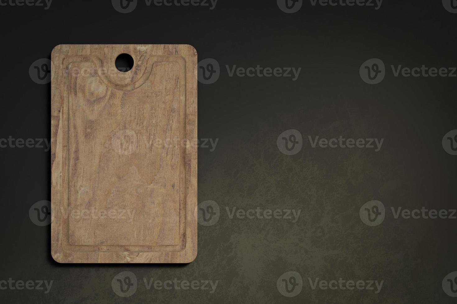 Old cutting board top view on dark background with empty space. photo