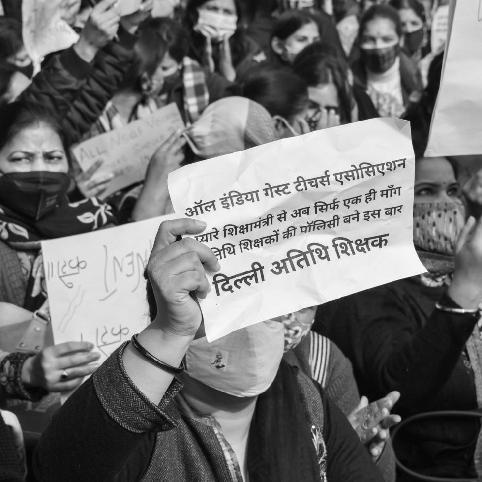 Delhi, India December 25 2021 - Delhi Contractual Guest Teachers with posters, flags and graffitis protesting against Delhi AAP Government for making policy, Delhi Teacher protesting Black and White photo
