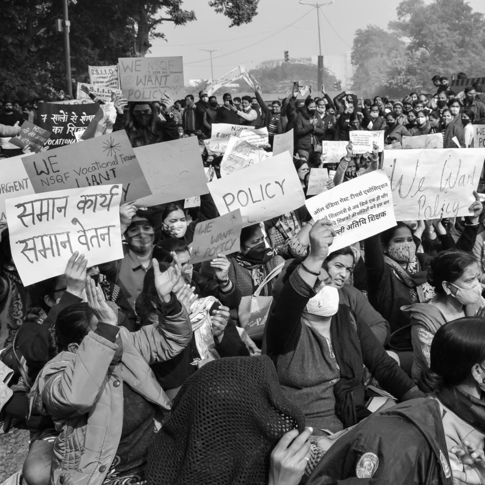 Delhi, India December 25 2021 - Delhi Contractual Guest Teachers with posters, flags and graffitis protesting against Delhi AAP Government for making policy, Delhi Teacher protesting Black and White photo