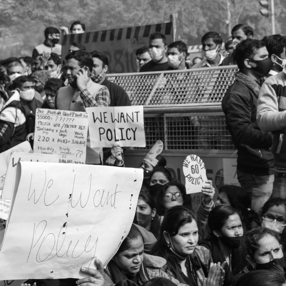 Delhi, India December 25 2021 - Delhi Contractual Guest Teachers with posters, flags and graffitis protesting against Delhi AAP Government for making policy, Delhi Teacher protesting Black and White photo