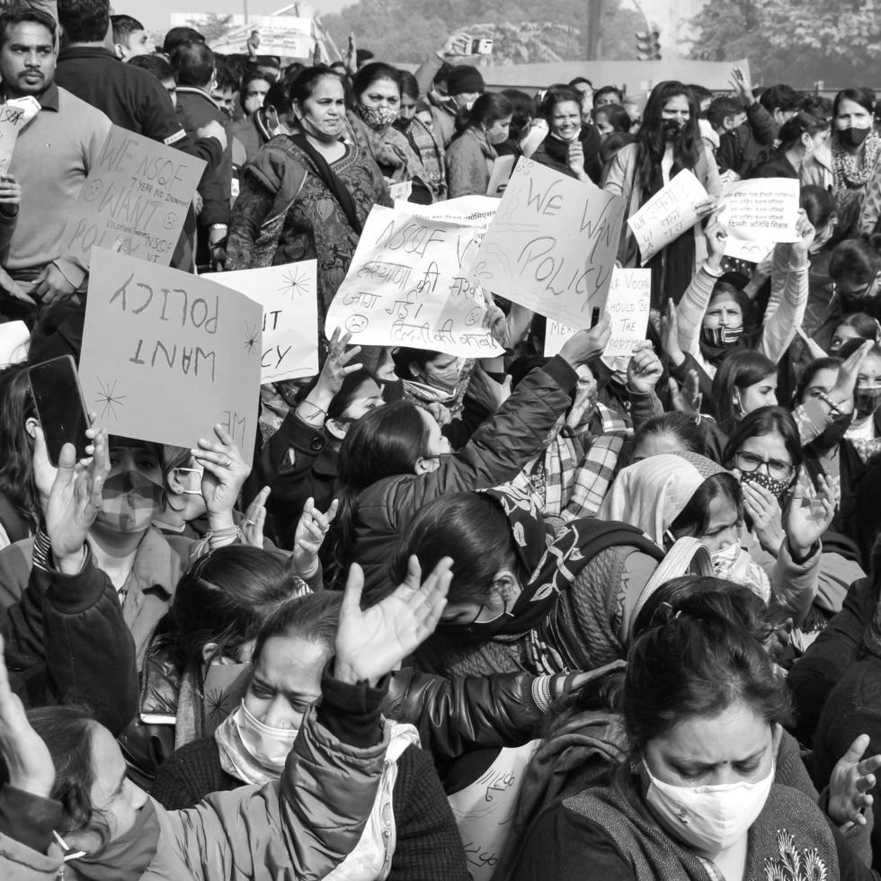 Delhi, India December 25 2021 - Delhi Contractual Guest Teachers with posters, flags and graffitis protesting against Delhi AAP Government for making policy, Delhi Teacher protesting Black and White photo