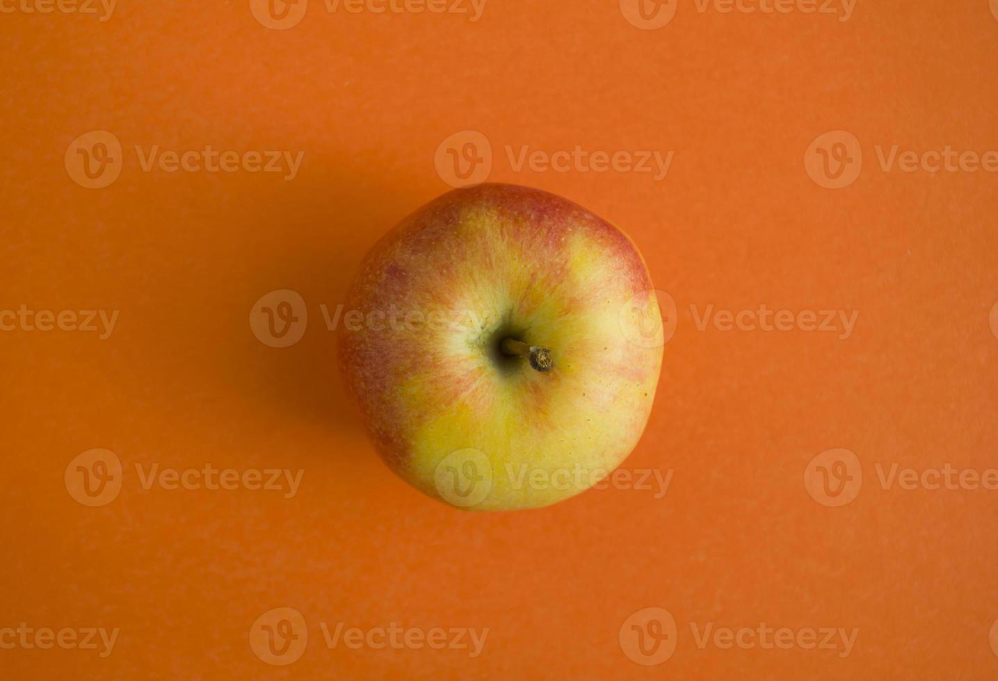 Apple on an orange background photo