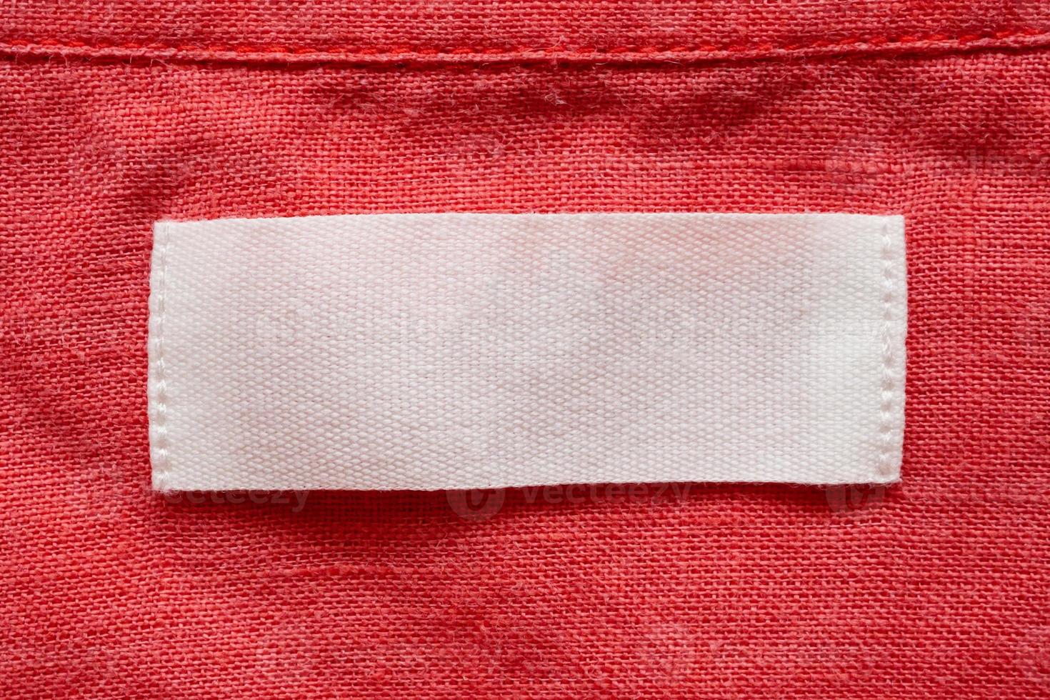 Blank clothing tag label on linen shirt fabric texture background photo