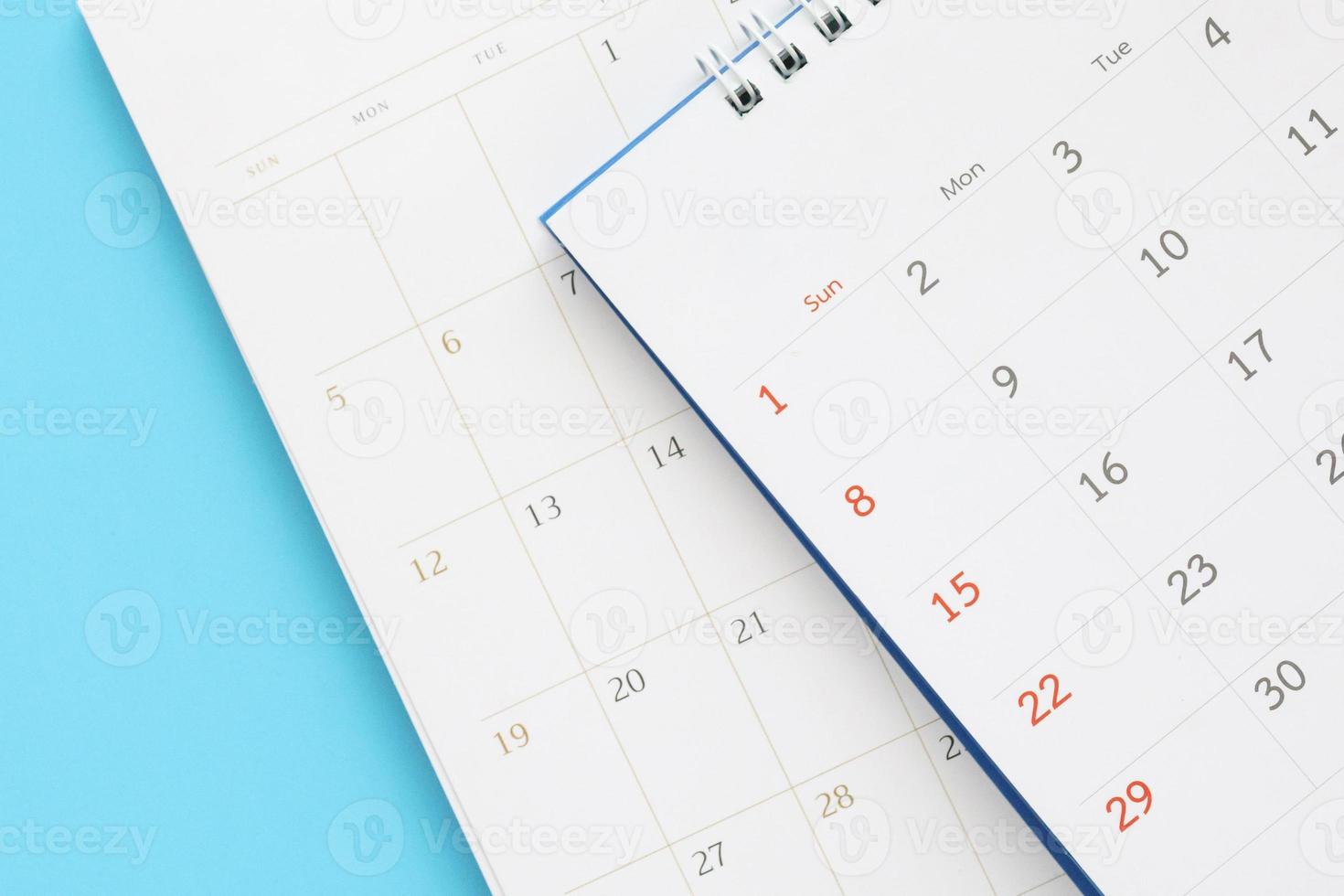 calendar page close up on blue background business planning appointment meeting concept photo