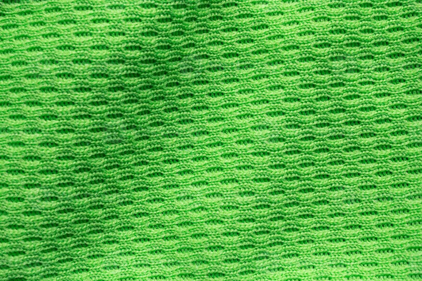 Green sports clothing fabric football shirt jersey texture close up photo