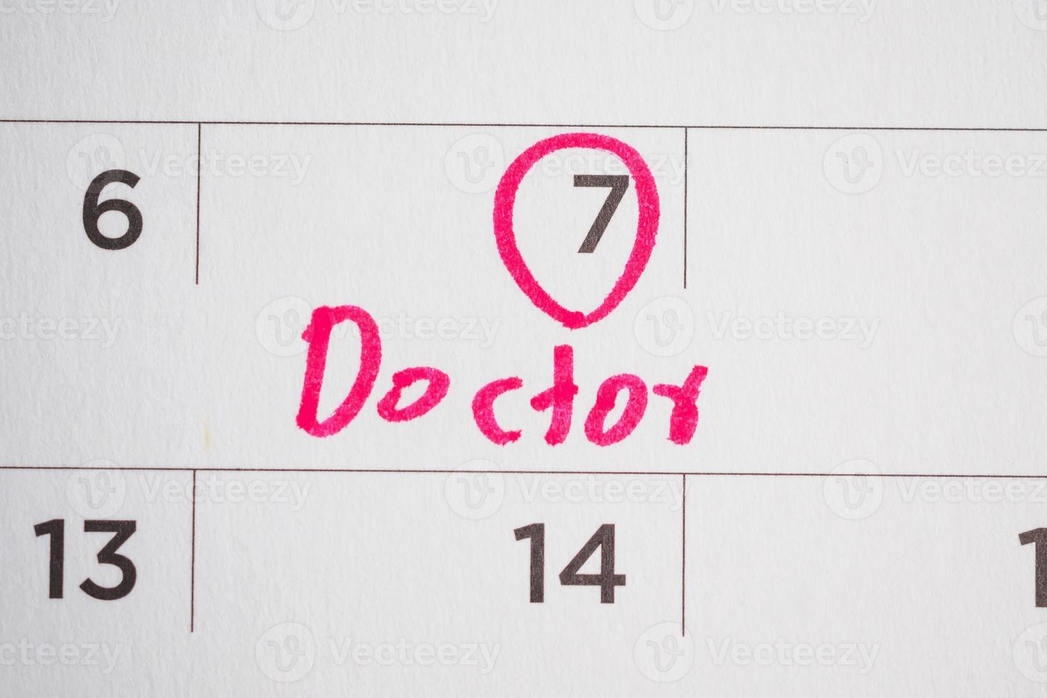 important doctor appointment schedule write on white calendar page date close up photo