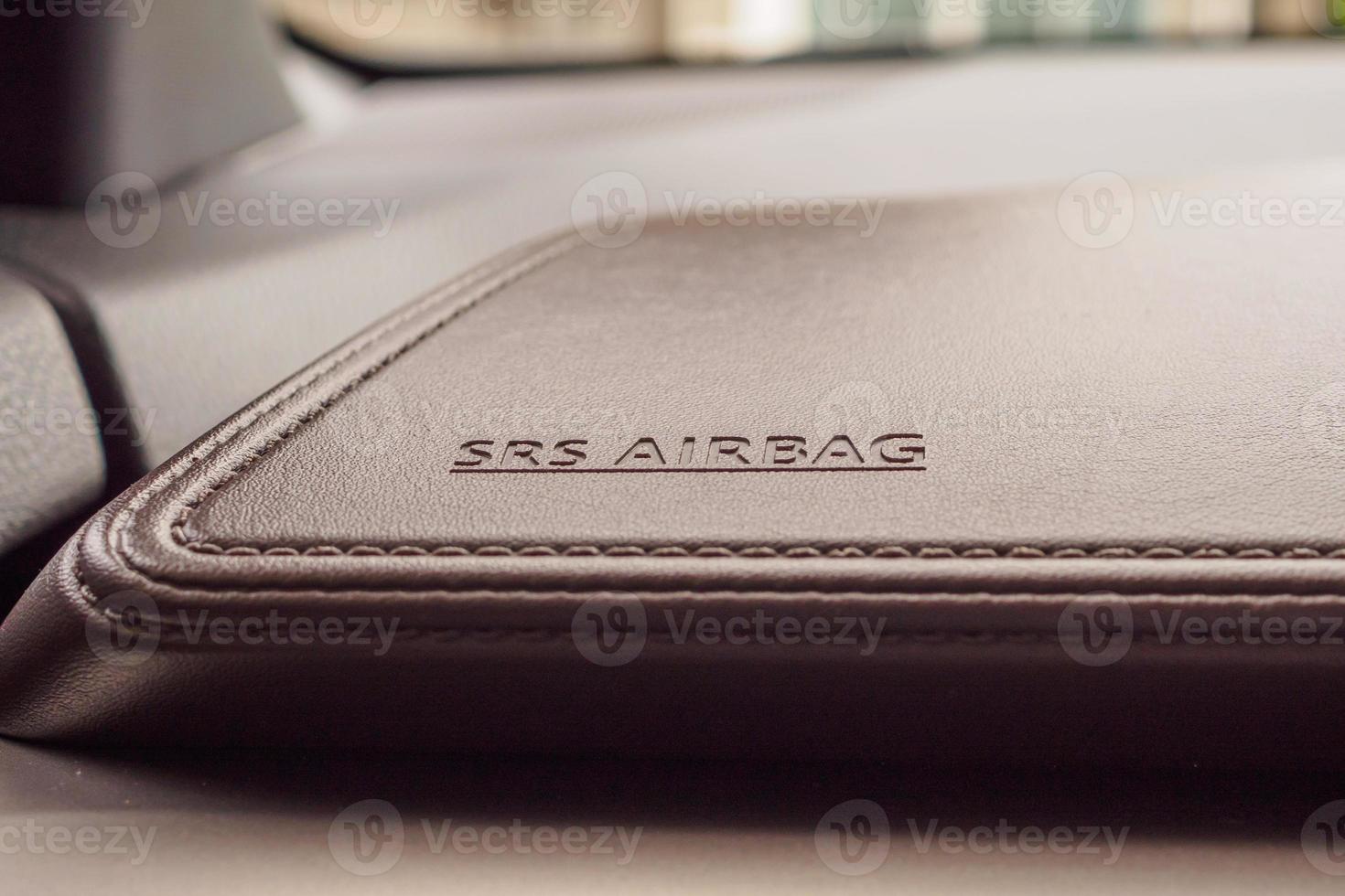 airbag safety sign on brown leather texture in modern car photo