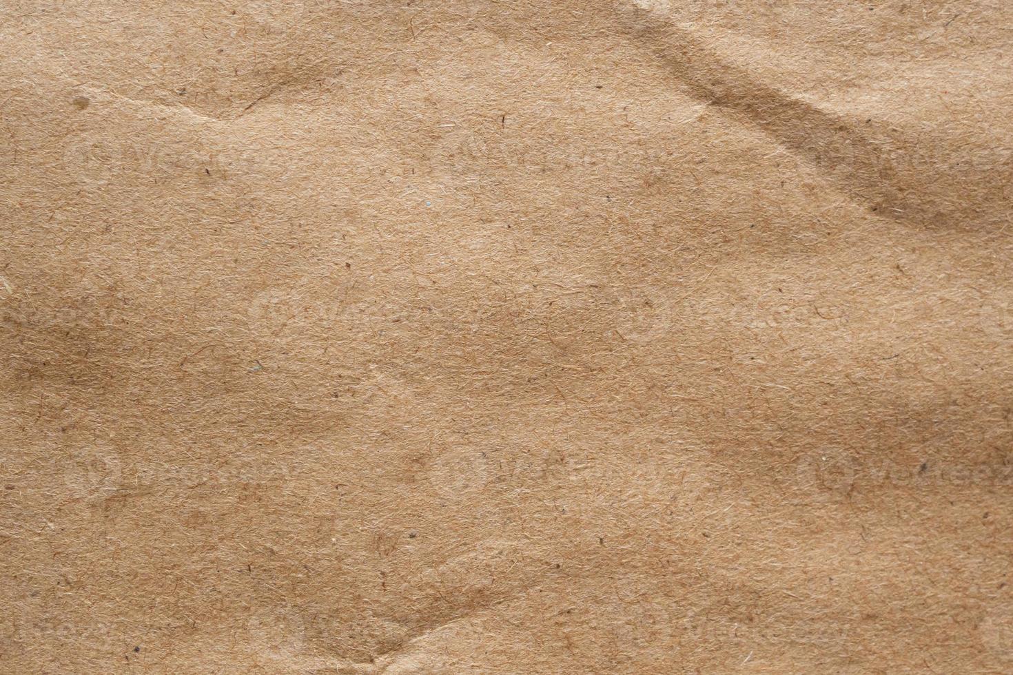 Brown crumpled paper recycled kraft sheet texture background photo
