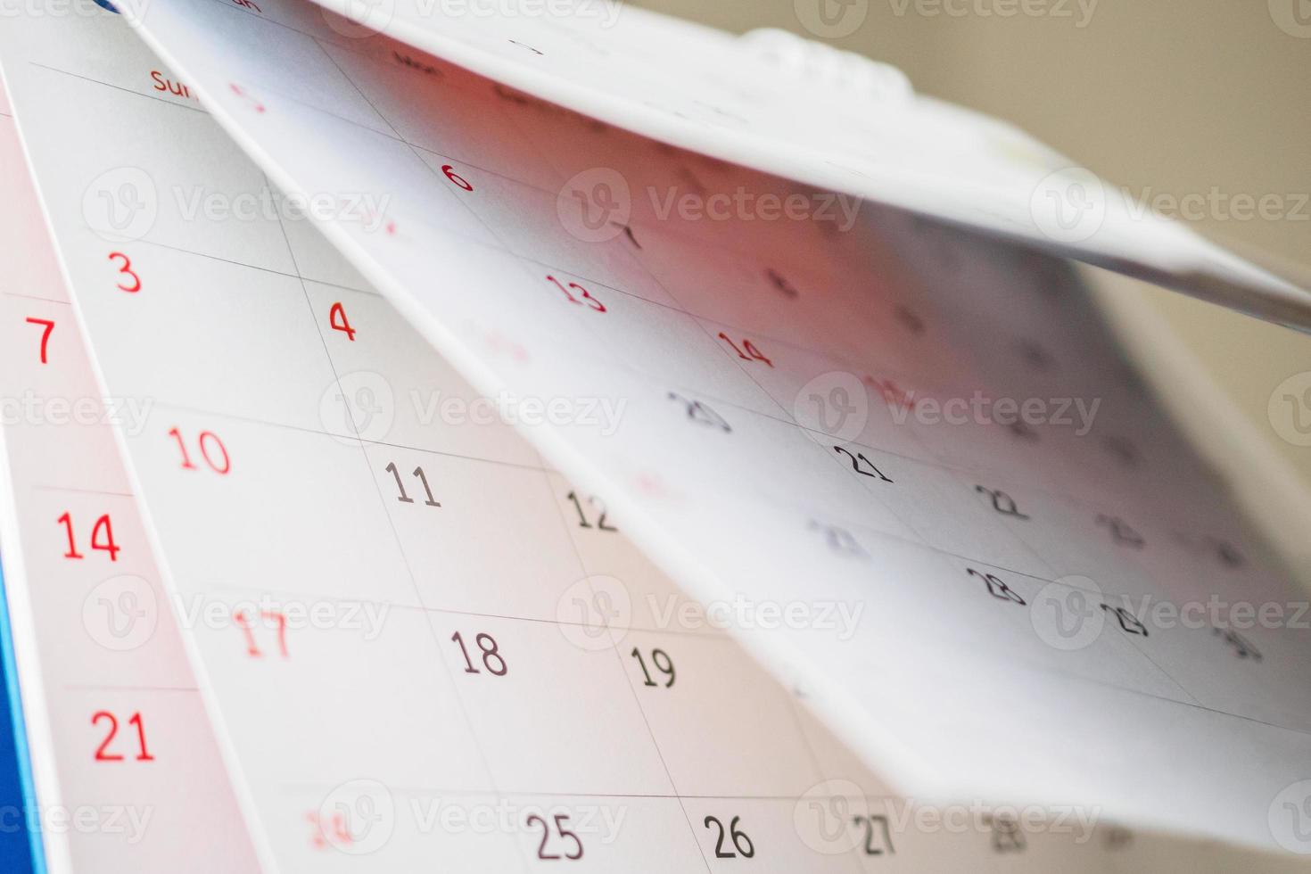 Calendar page flipping sheet close up on office table background business schedule planning appointment meeting concept photo