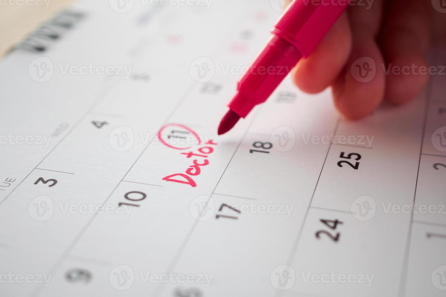 important doctor appointment schedule write on white calendar page date close up photo